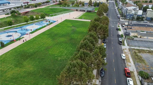 an aerial view of residential houses with outdoor space and street view