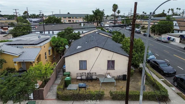a view of a patio with table and chairs and potted plants