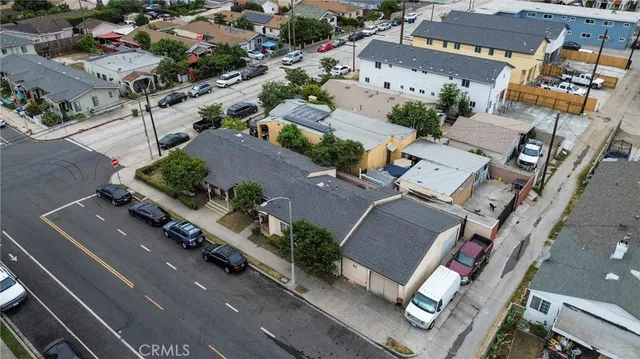 an aerial view of multiple houses with yard