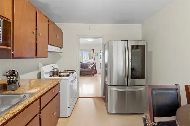 a kitchen with a sink appliances and cabinets