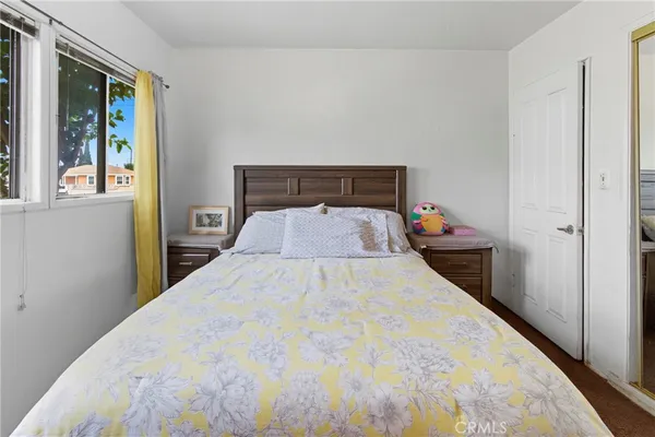 a bed room with a bed and a window