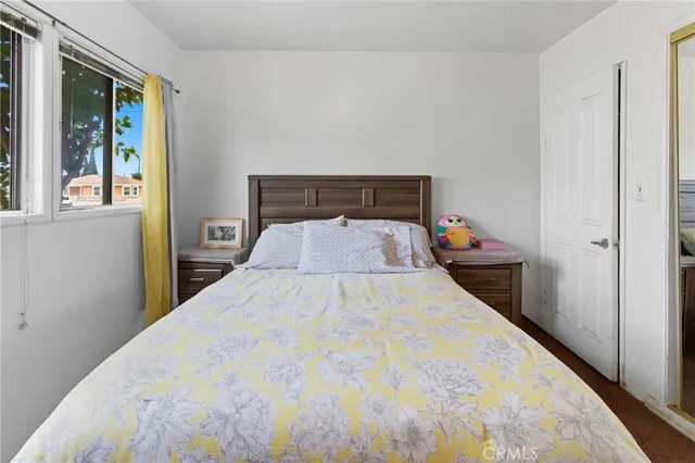 a bed room with a bed and a window