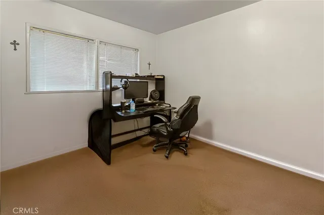 a view of workspace with chair and window