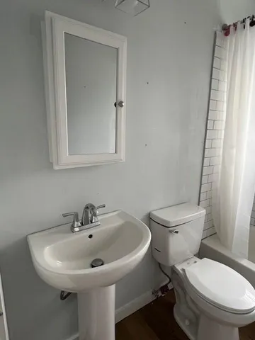 a white toilet sitting next to a bathroom sink