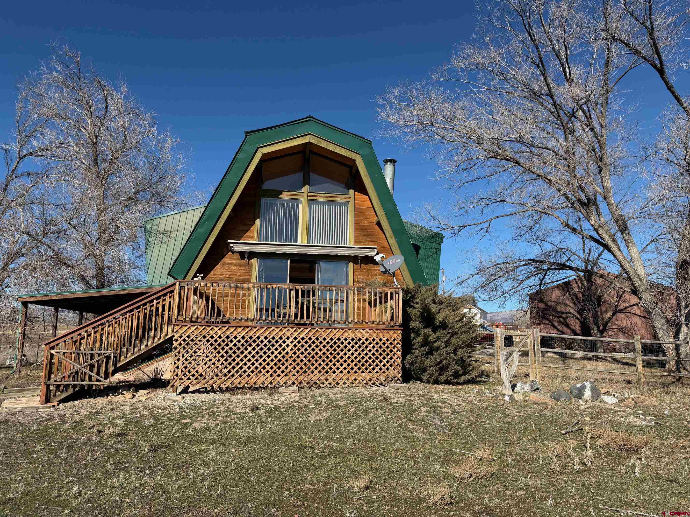 25926 Q25 Road Cedaredge, CO 81413 - Photo 2 of 32 a view of a brick house with large windows