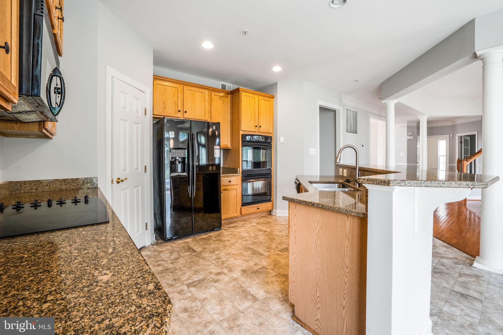 14108 Chivas Circle Laurel, MD 20707 - Photo 11 of 51 a kitchen with stainless steel appliances granite countertop a refrigerator and a sink