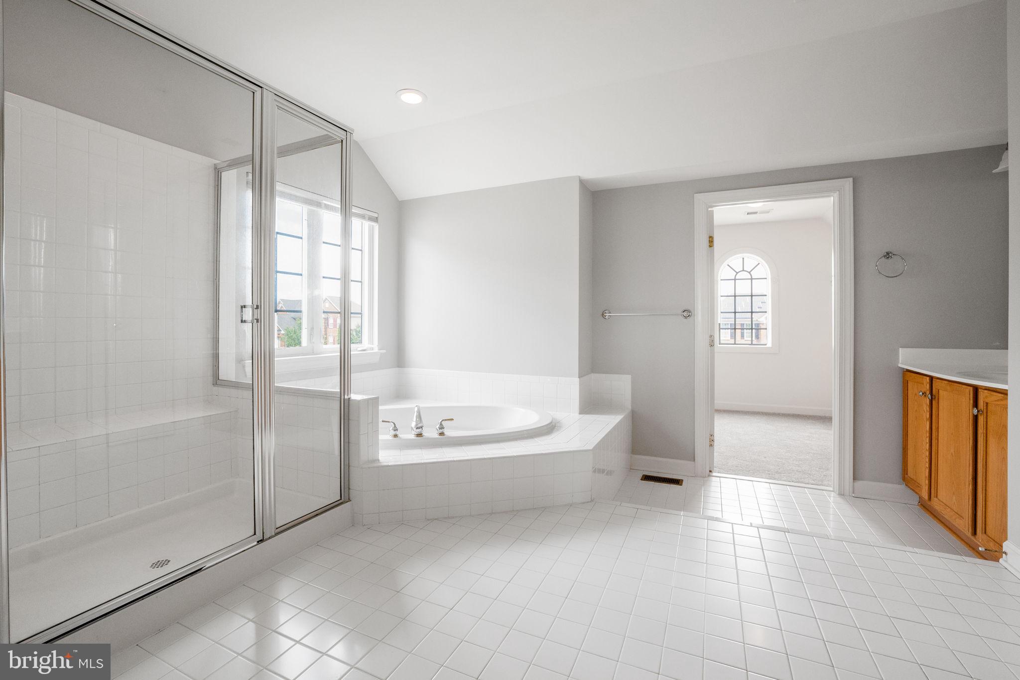 14108 Chivas Circle Laurel, MD 20707 - Photo 25 of 51 a spacious bathroom with a bathtub and a shower
