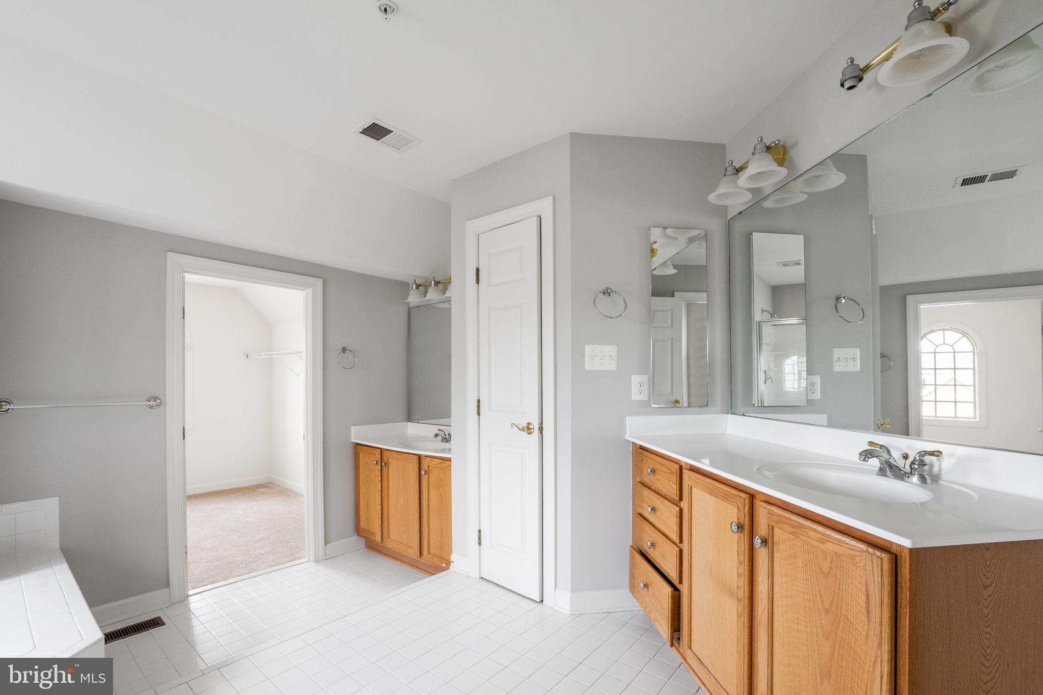 14108 Chivas Circle Laurel, MD 20707 - Photo 28 of 51 a spacious bathroom with a granite countertop sink mirror and a shower