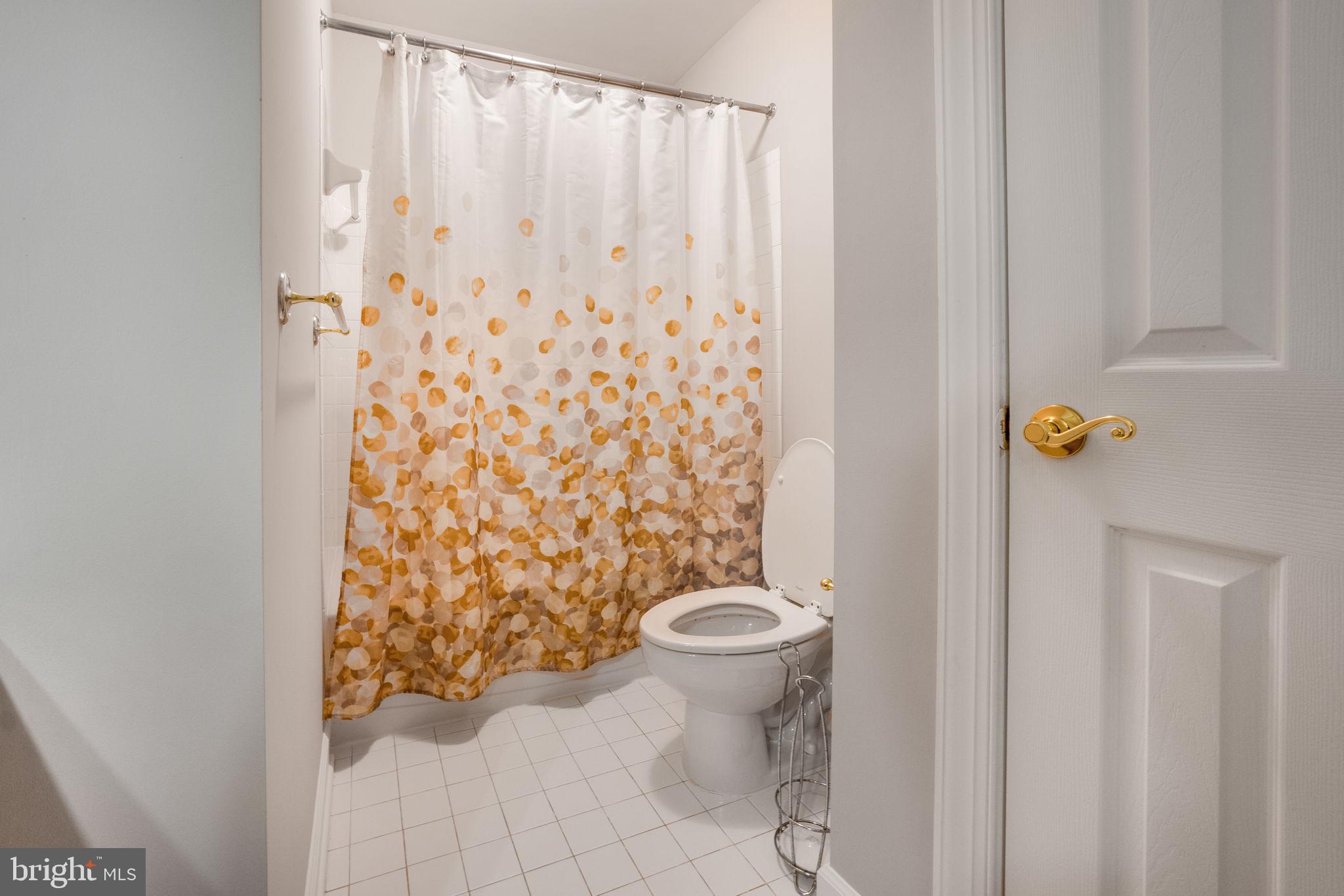 14108 Chivas Circle Laurel, MD 20707 - Photo 31 of 51 a white toilet sitting next to a shower curtain