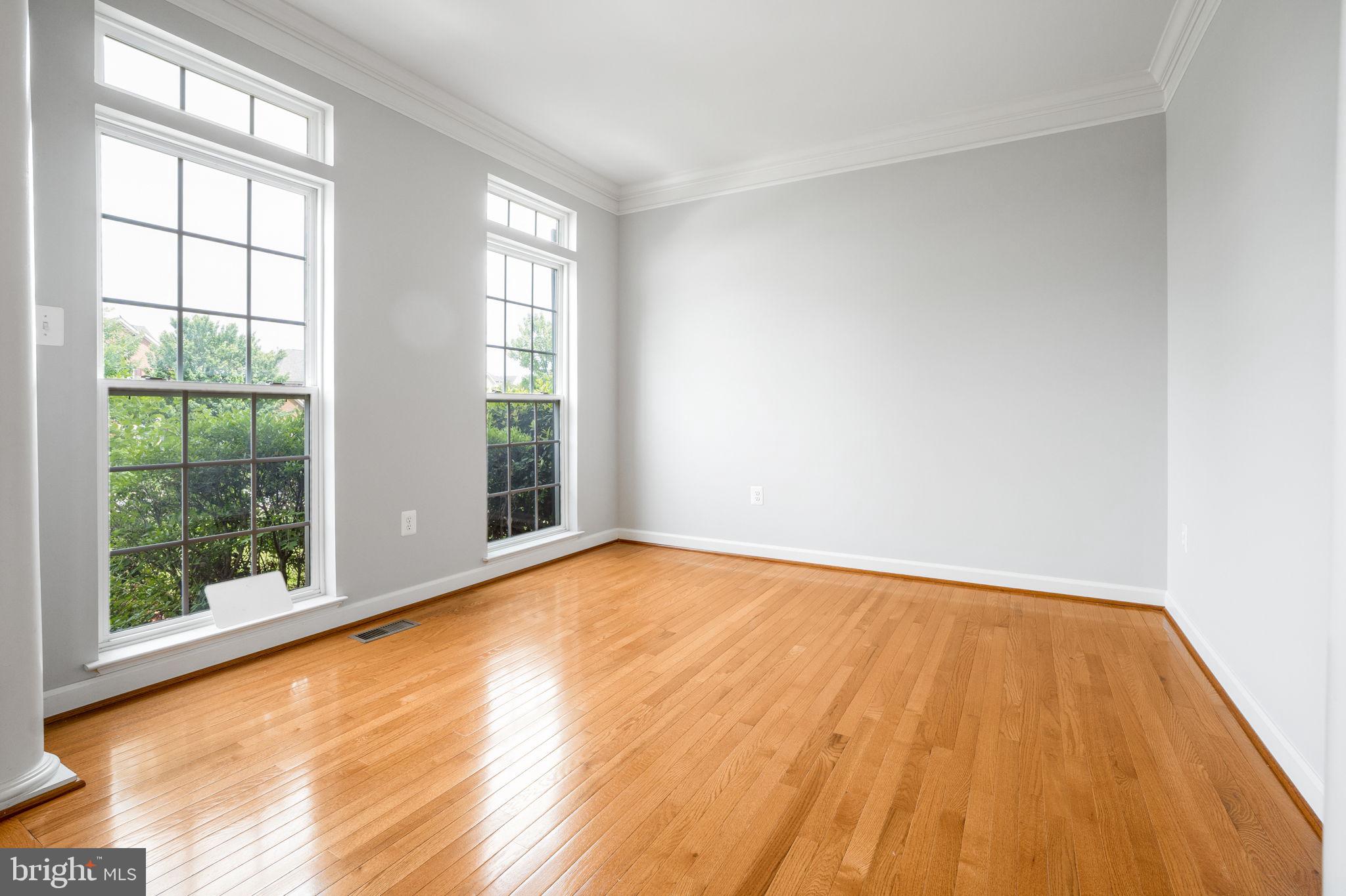 14108 Chivas Circle Laurel, MD 20707 - Photo 5 of 51 a view of an empty room with wooden floor and a window