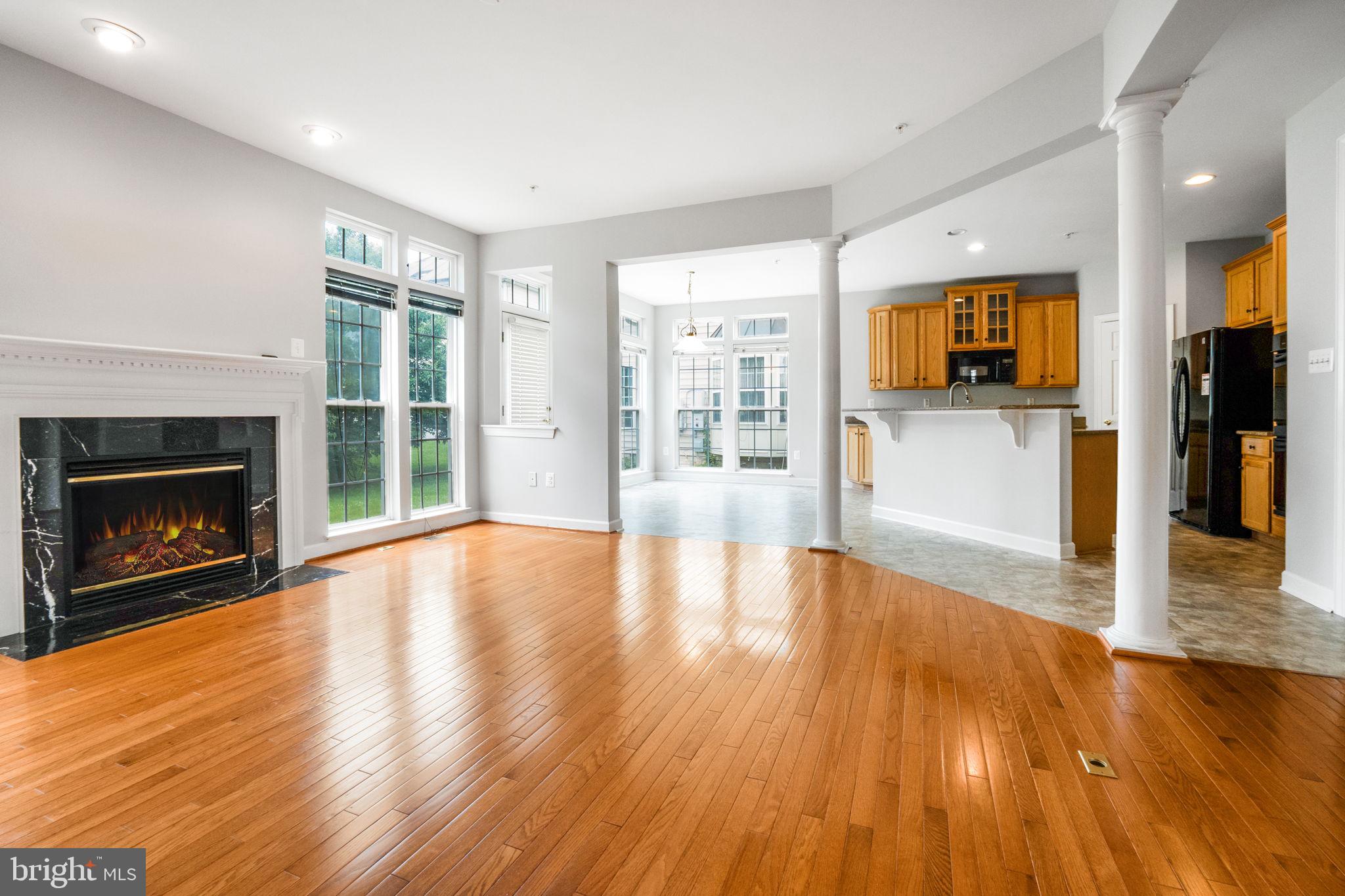 14108 Chivas Circle Laurel, MD 20707 - Photo 8 of 51 a view of a livingroom with wooden floor and a fireplace