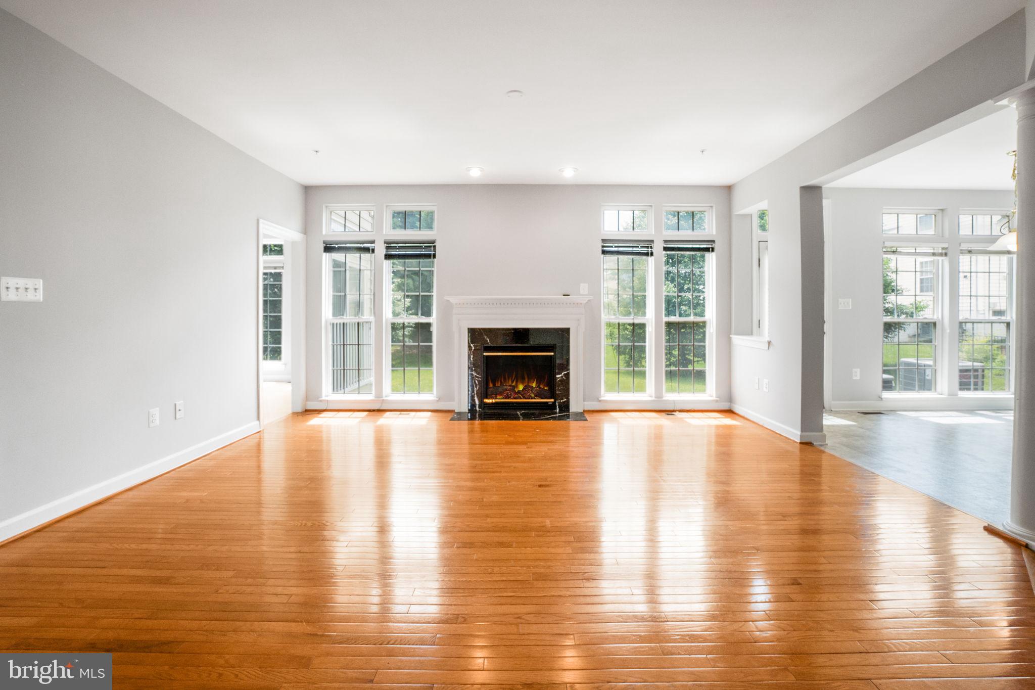 14108 Chivas Circle Laurel, MD 20707 - Photo 9 of 51 a view of empty room with wooden floor and fireplace