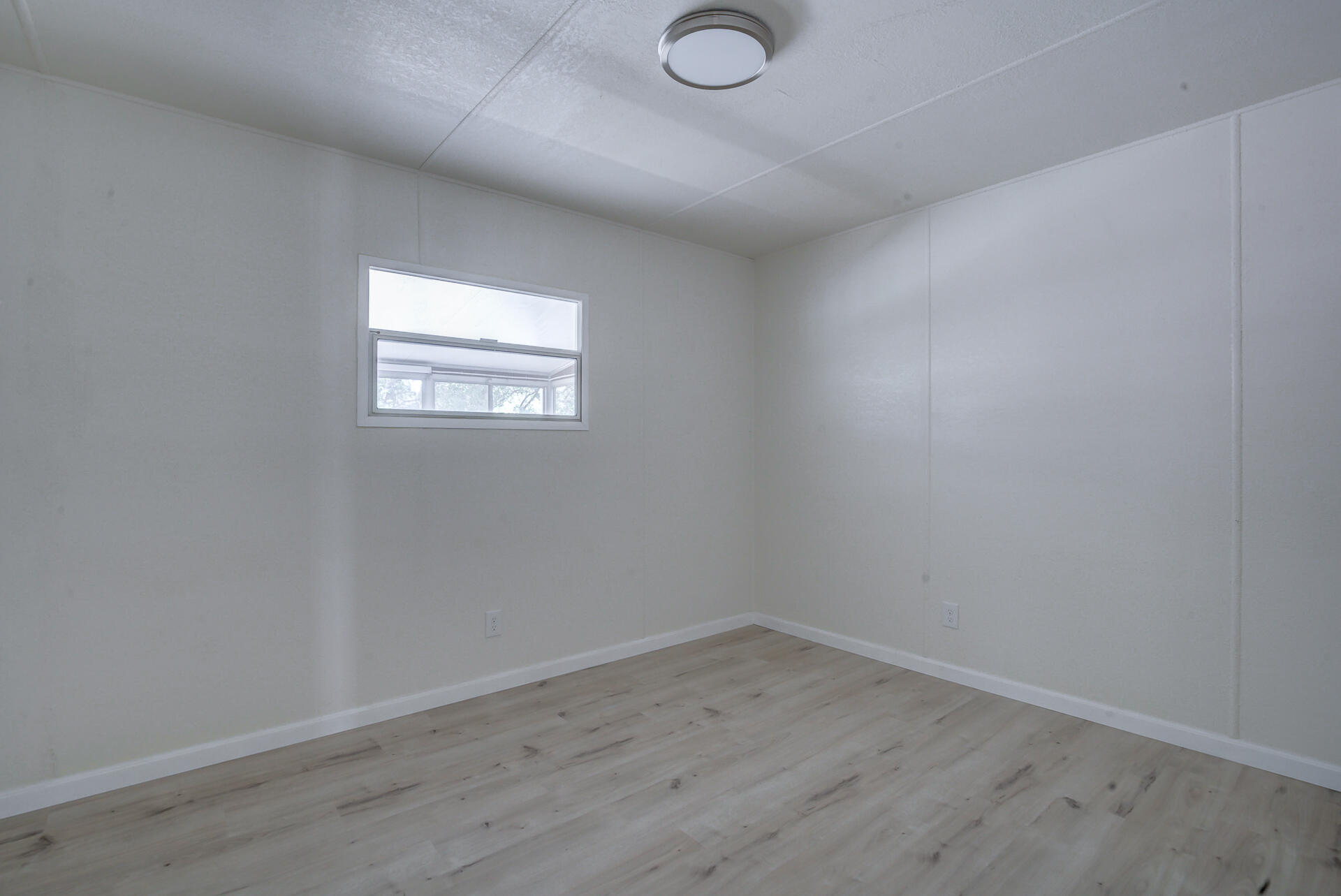 821 St Marks Street, Unit 1 Redding, CA 96003 - Photo 14 of 26 an empty room with wooden floor and windows