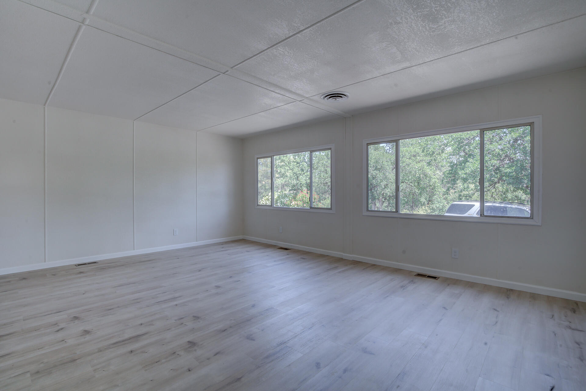 821 St Marks Street, Unit 1 Redding, CA 96003 - Photo 3 of 26 an empty room with wooden floor and windows
