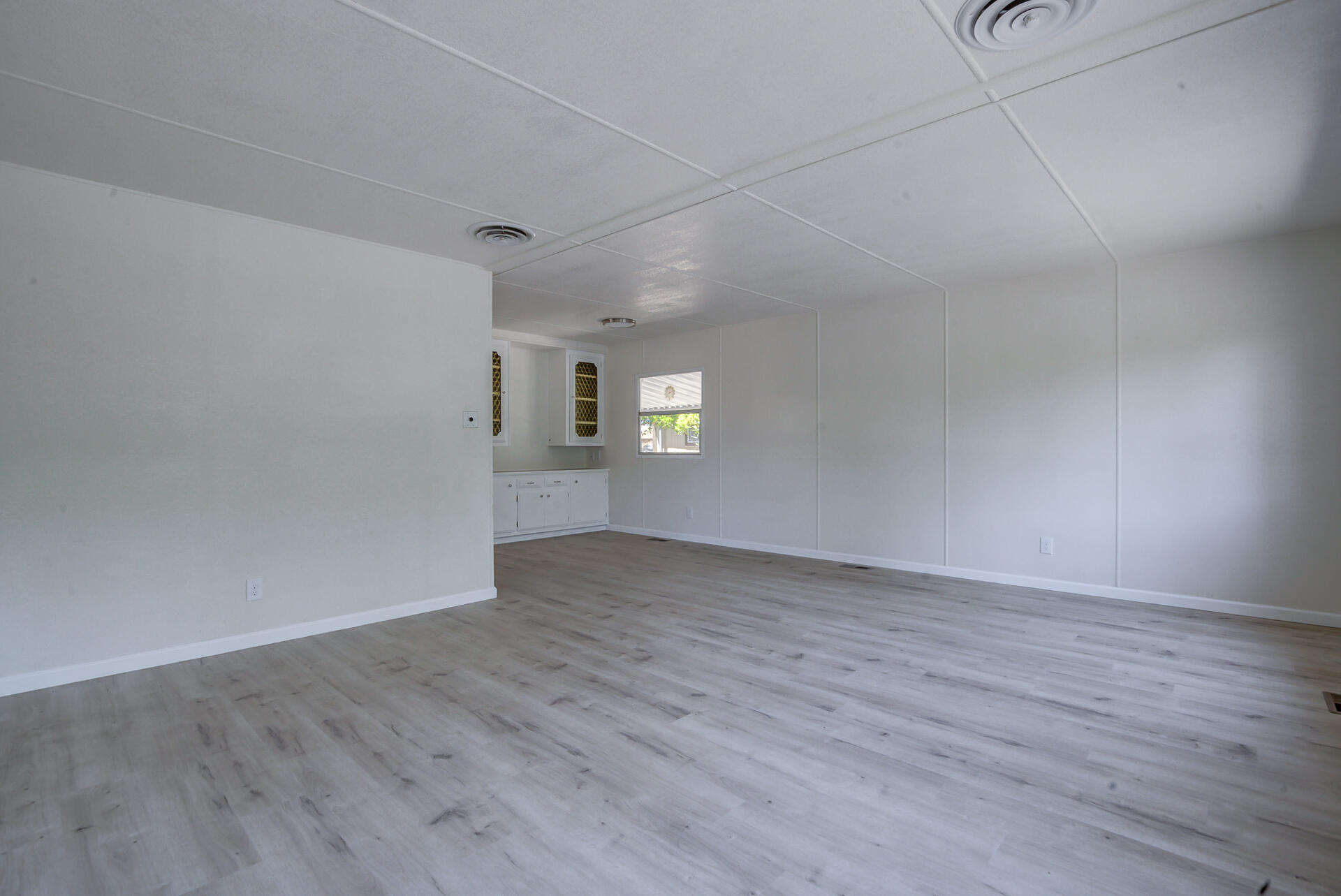 821 St Marks Street, Unit 1 Redding, CA 96003 - Photo 4 of 26 a view of empty room with wooden floor and fan
