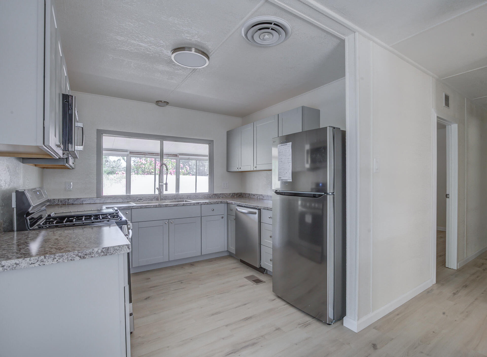 821 St Marks Street, Unit 1 Redding, CA 96003 - Photo 8 of 26 a kitchen with a refrigerator stove top oven and sink