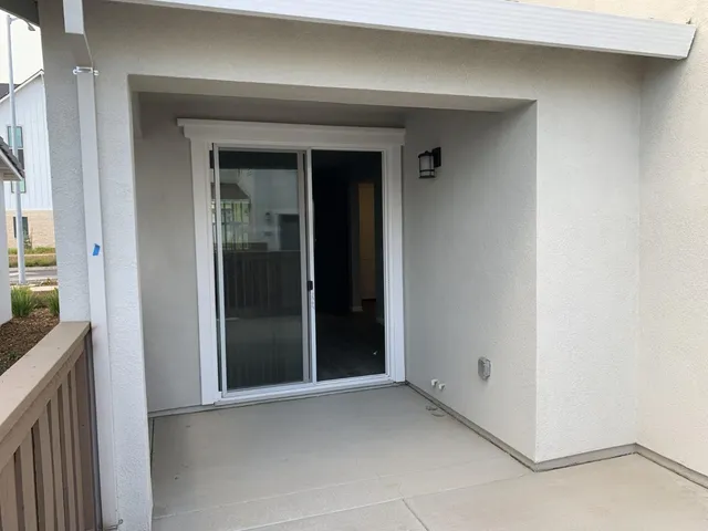 a view of a house with wooden fence