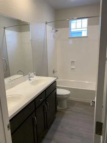 a kitchen with a sink a stove and cabinets