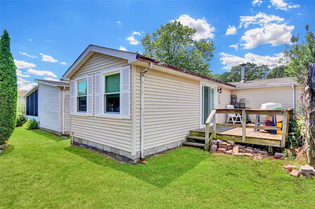 a view of a house with backyard and sitting area