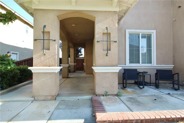 a view of a patio with table and chairs and potted plants