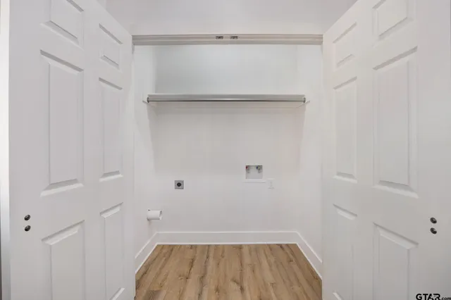 a view of a room with wooden floor