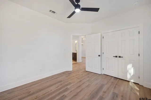 a view of an empty room and wooden floor