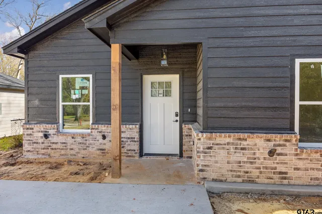 a front view of a house with large windows