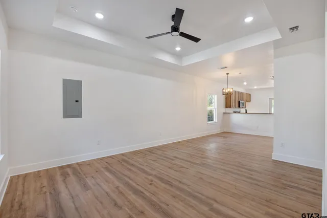 a view of a kitchen with a dishwasher and wooden floor