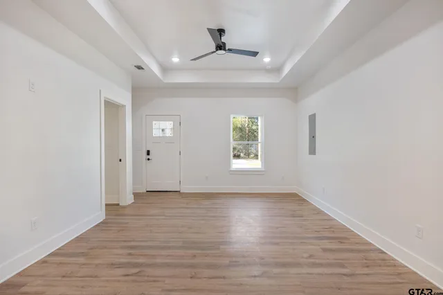 wooden floor in an empty room with a window