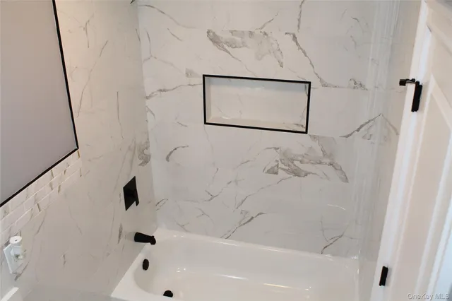 a bathroom with a shower and a mirror