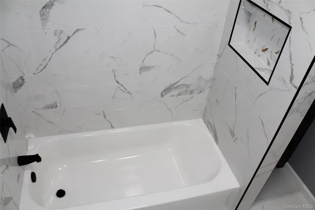 a white toilet sitting next to a white sink