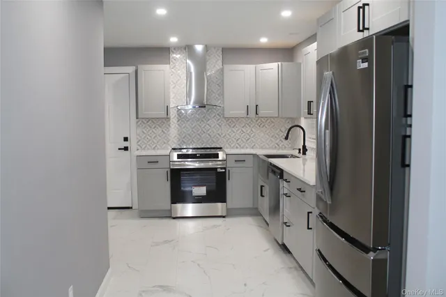 a kitchen with stainless steel appliances a refrigerator sink and stove
