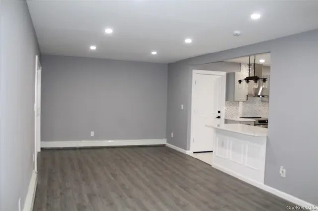 a view of room with window and wooden floor