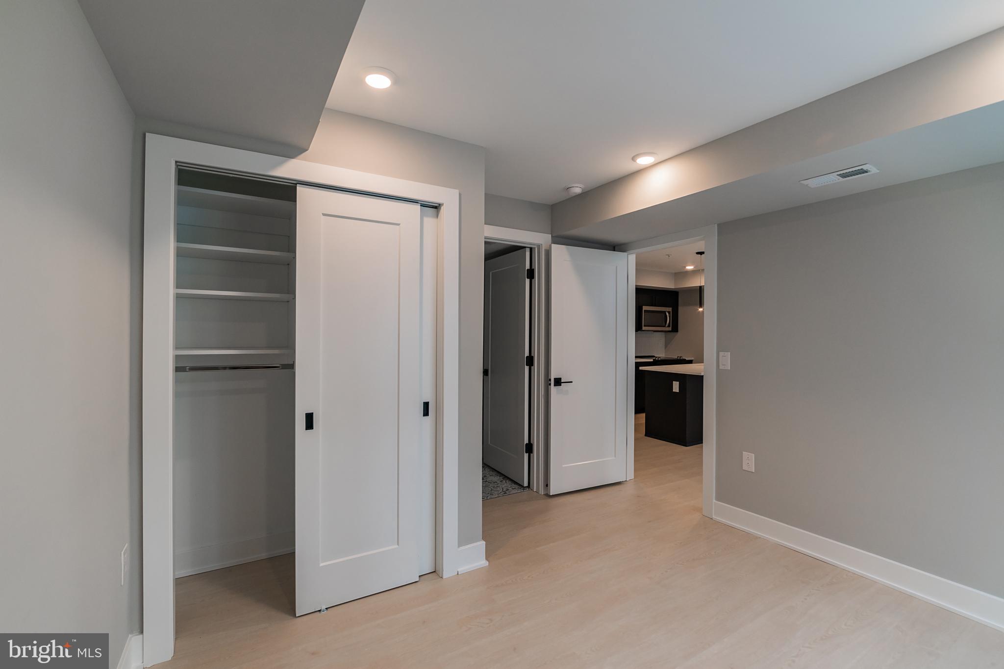 6604 Ridge Avenue, Unit 302 Philadelphia, PA 19128 - Photo 11 of 11 a view of hallway with closet and wooden shelves