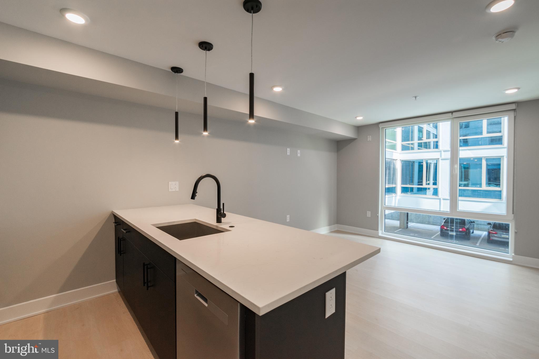6604 Ridge Avenue, Unit 302 Philadelphia, PA 19128 - Photo 2 of 11 a kitchen with a sink and a refrigerator
