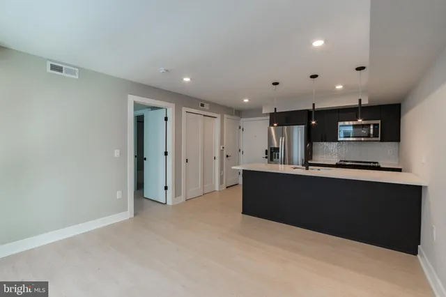 a view of kitchen with stainless steel appliances kitchen island
