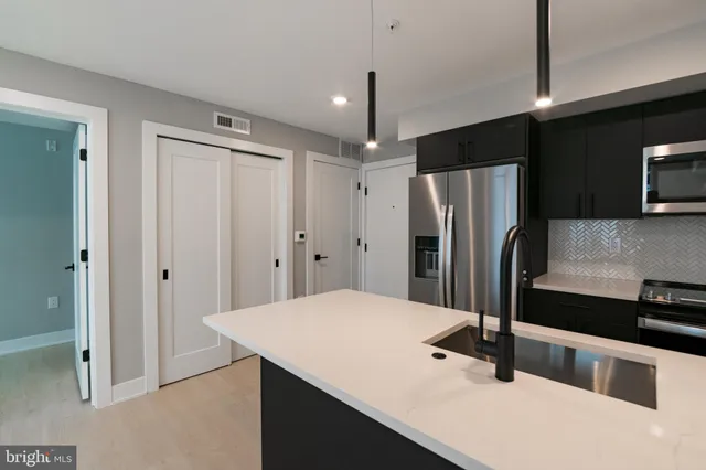 a kitchen with stainless steel appliances a refrigerator and a sink