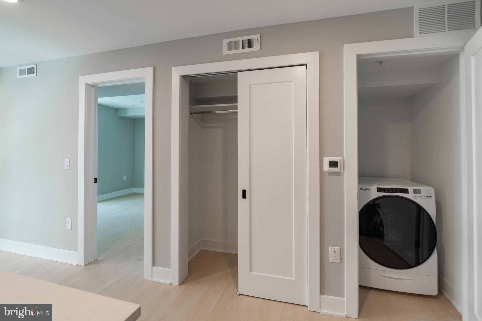 6604 Ridge Avenue, Unit 302 Philadelphia, PA 19128 - Photo 6 of 11 a view of a hallway with washer and dryer