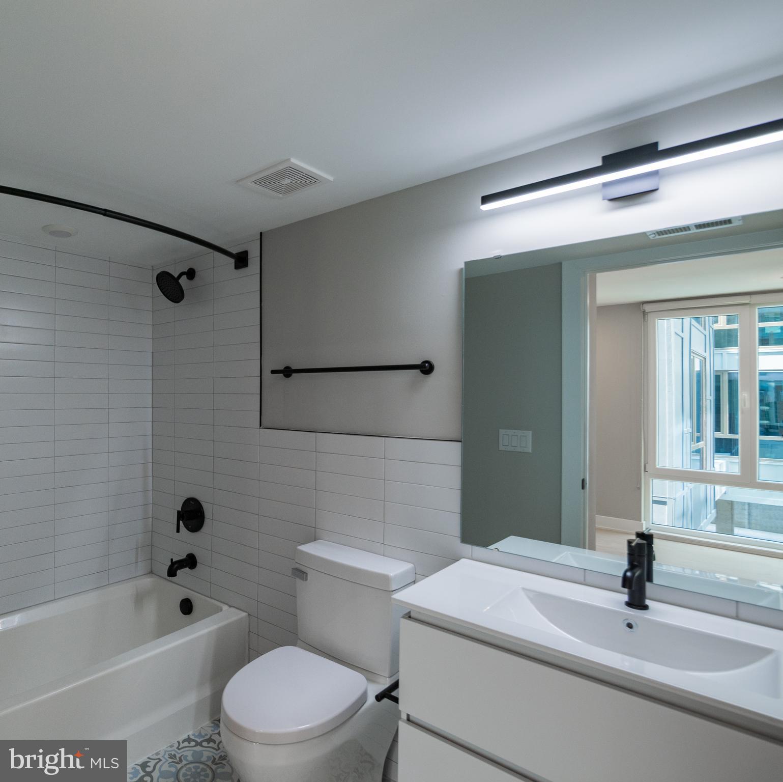 6604 Ridge Avenue, Unit 302 Philadelphia, PA 19128 - Photo 7 of 11 a bathroom with a sink toilet and shower