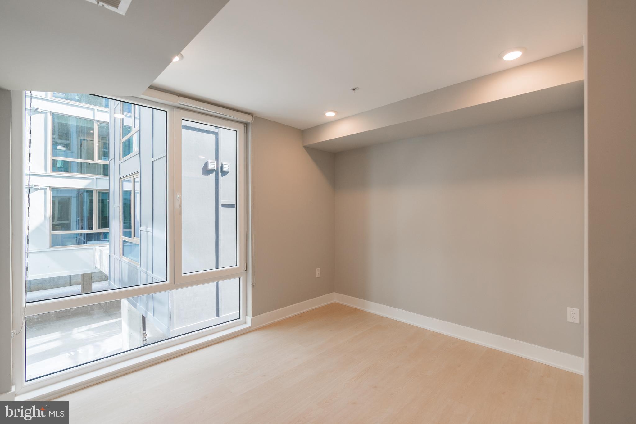 6604 Ridge Avenue, Unit 302 Philadelphia, PA 19128 - Photo 9 of 11 an empty room with windows