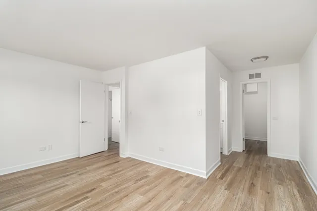 a view of a room with wooden floor