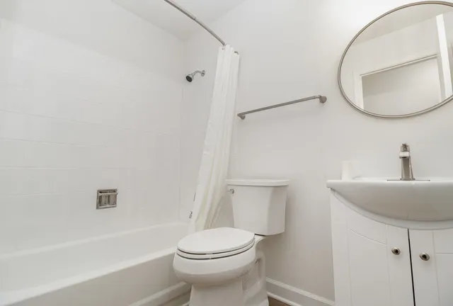 a bathroom with a sink toilet and a mirror