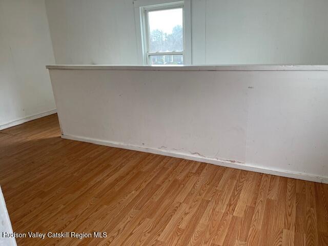 676 Highway 145 Cairo, NY 12413 - Photo 13 of 25 an empty room with wooden floor and windows