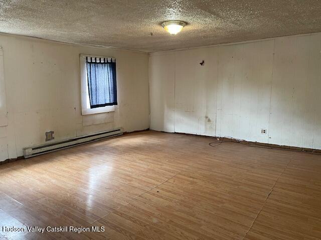676 Highway 145 Cairo, NY 12413 - Photo 10 of 25 an empty room with wooden floor and windows