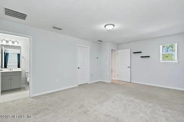 a living room with furniture and potted plants