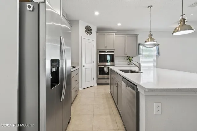 a kitchen with kitchen island a sink stainless steel appliances and cabinets