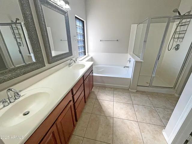 a bathroom with a bathtub sink and mirror