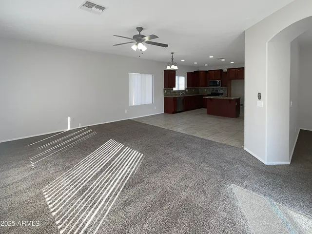 a view of kitchen and hall with a chandelier