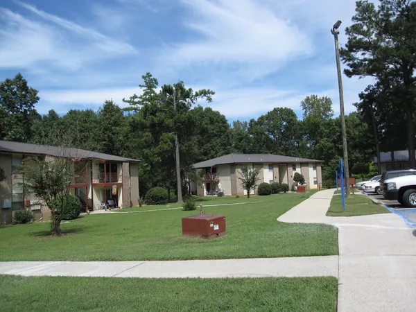 a view of a house with backyard and porch
