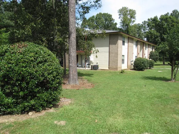 a view of a house with yard and tree s